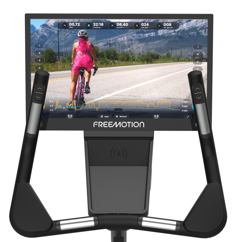 Black stationary exercise bike with seat, handlebars, and digital console on a white background