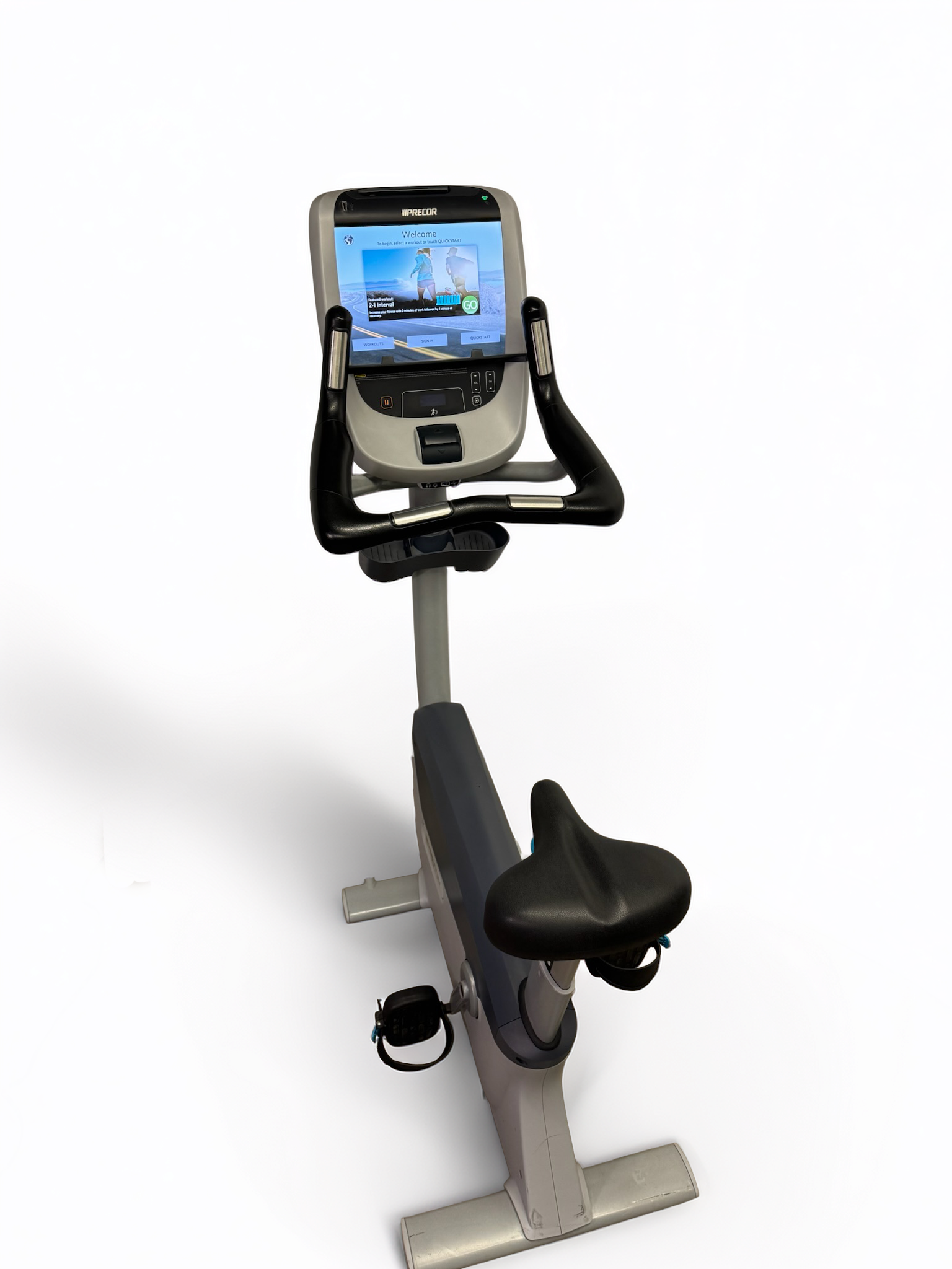 Stationary exercise bike with a console screen, black seat and handles on a gray frame.