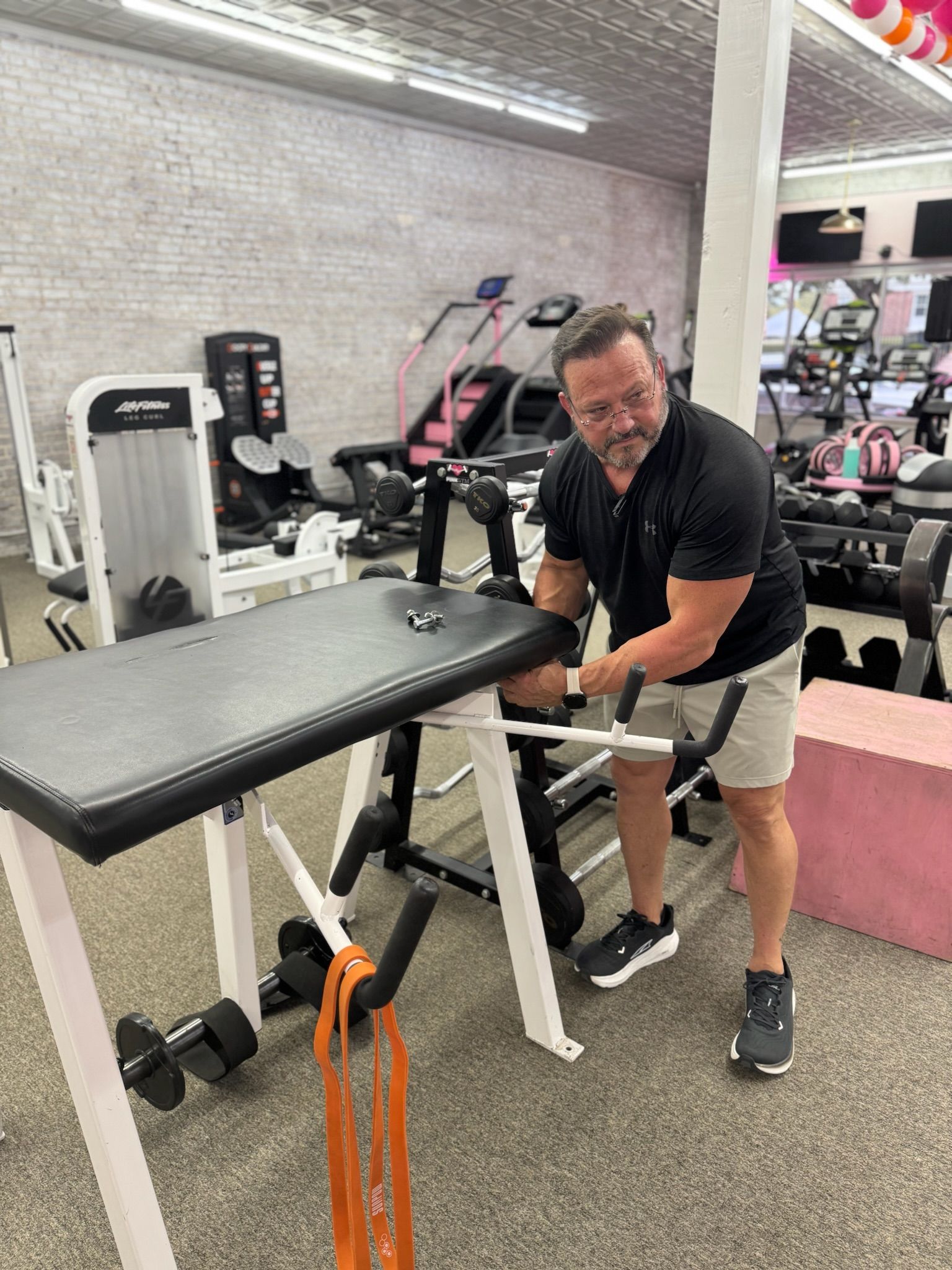 Man working on gym equipment.