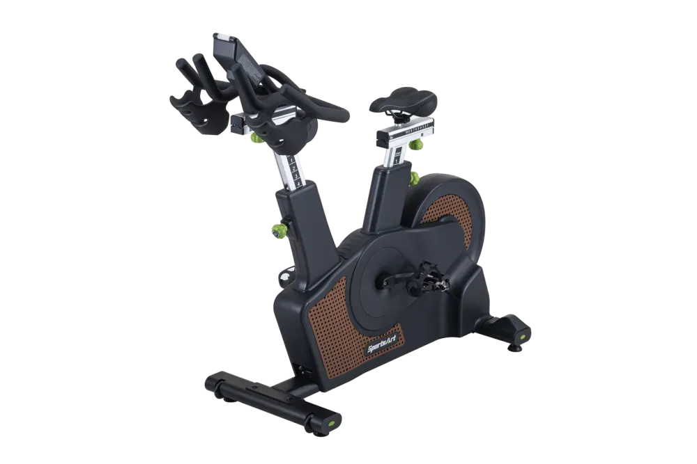 Indoor exercise bike with black frame and orange flywheel detail on a white background