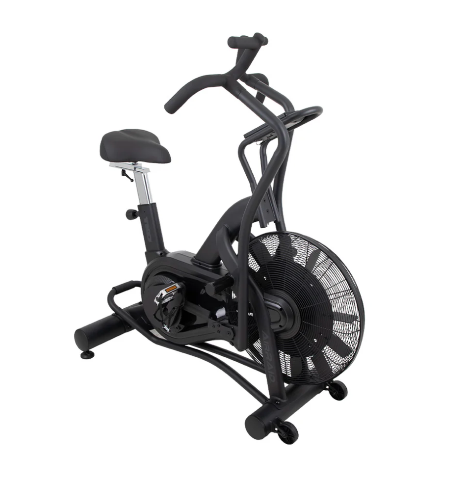 Black stationary exercise bike with fan wheel and adjustable seat on a white background