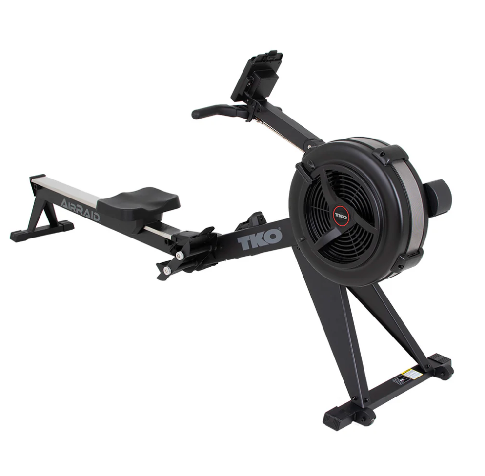 Black rowing machine with fan wheel and sliding seat on a white background