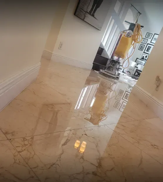 Polished marble hallway with reflections and a yellow coat hanging near a doorway