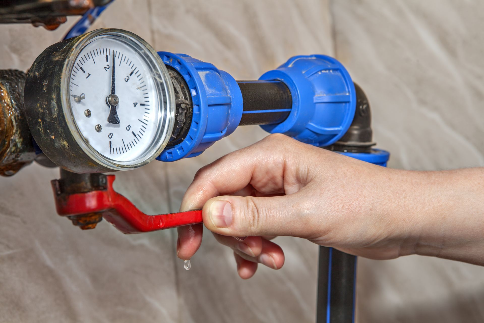a person is adjusting a pressure gauge on a pipe a person is adjusting a pressure gauge on a pipe