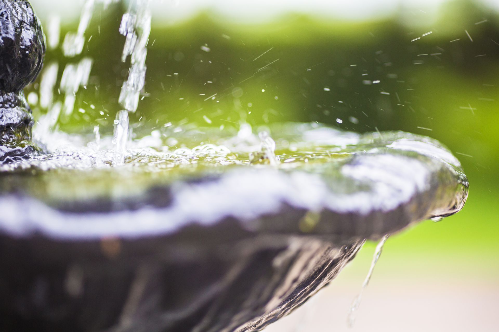 a close up of a fountain with water coming out of it a close up of a fountain with water coming out of it