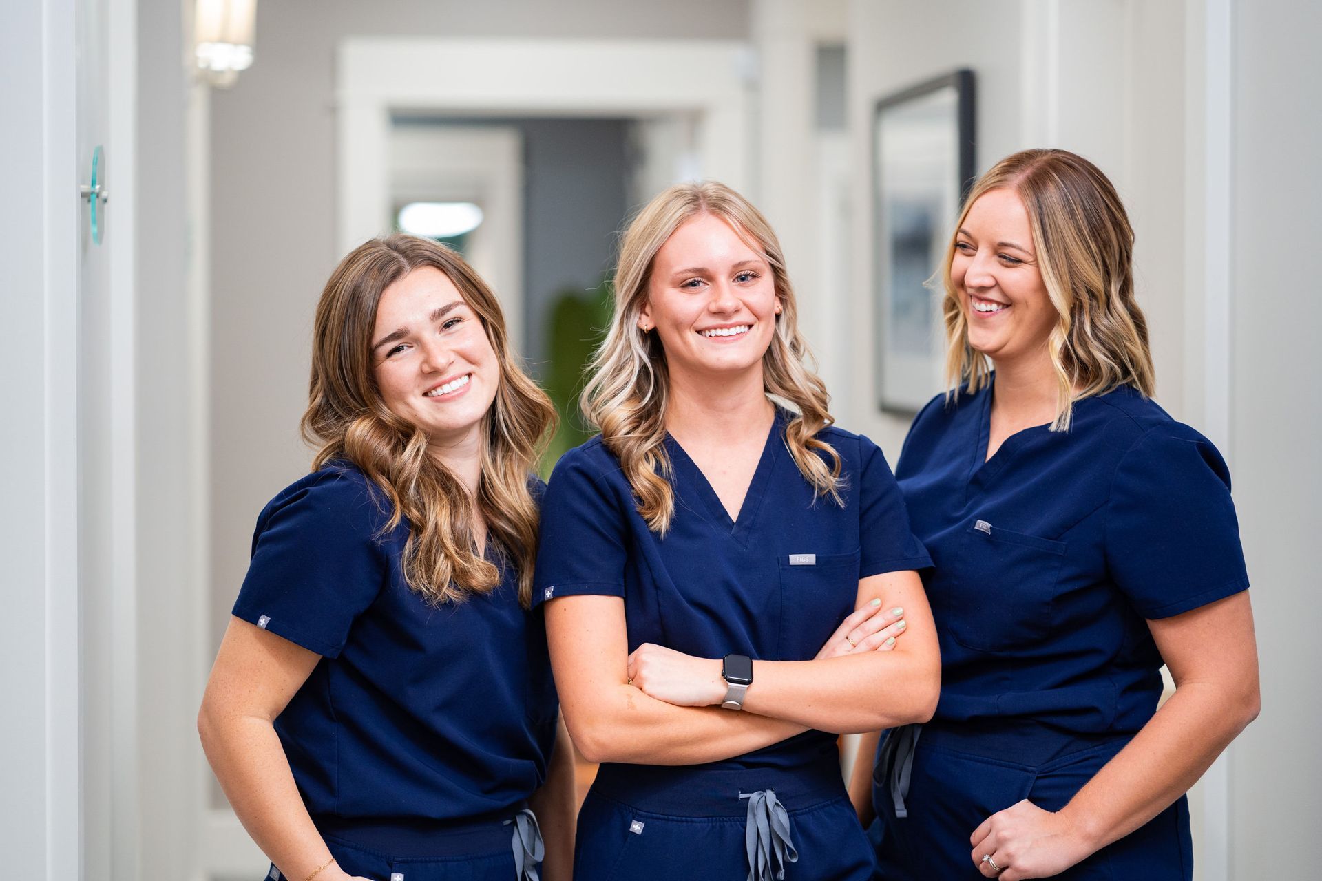 The McMahon Dental team smiling in a hallway.