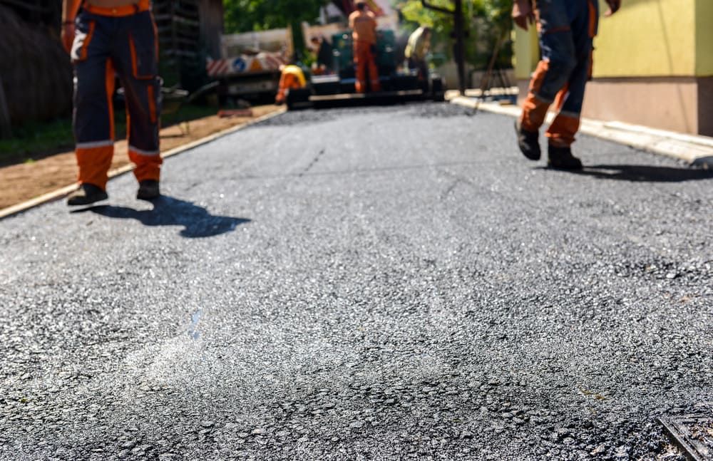 A Group of Construction Workers Are Walking Down a Road — Simon Dickson Excavations in Moss Vale, NSW
