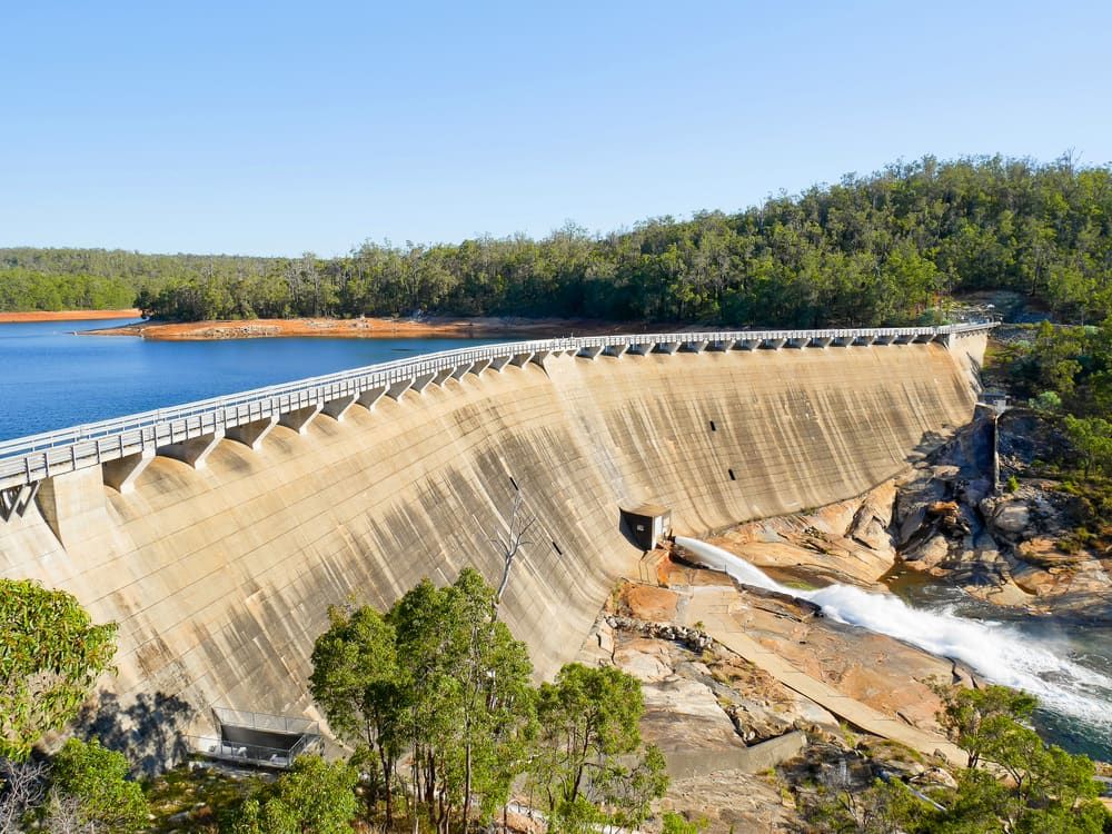 An Aerial View of a Dam Surrounded by Trees and Water — Simon Dickson Excavations in Moss Vale, NSW