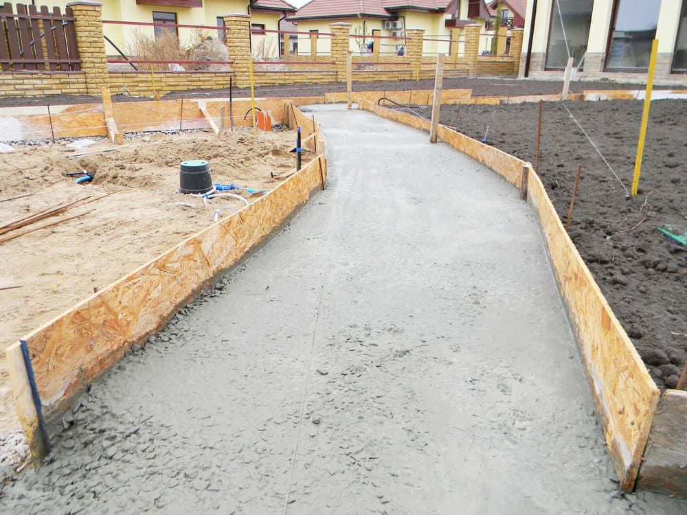 A Concrete Walkway is Being Built in a Construction Site — Simon Dickson Excavations in Moss Vale, NSW