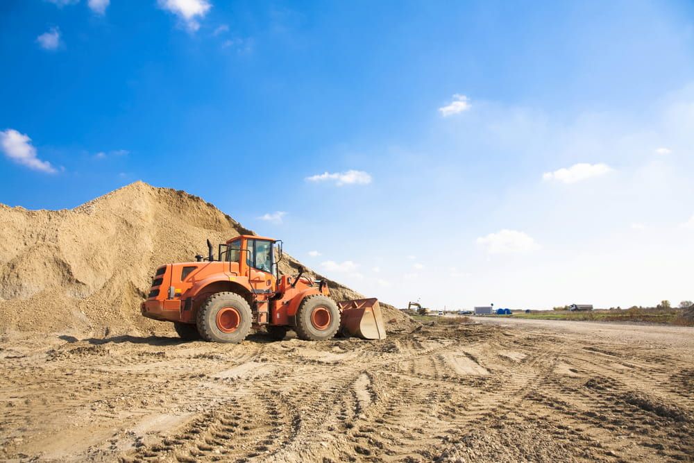 A Bulldozer is Sitting on Top of a Pile of Dirt — Simon Dickson Excavations in Bowral, NSW