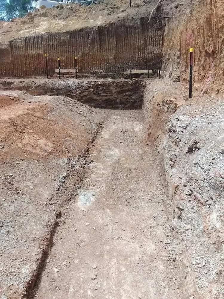 A Dirt Road Leading to a Hole in the Ground on a Construction Site — Simon Dickson Excavations in Moss Vale, NSW