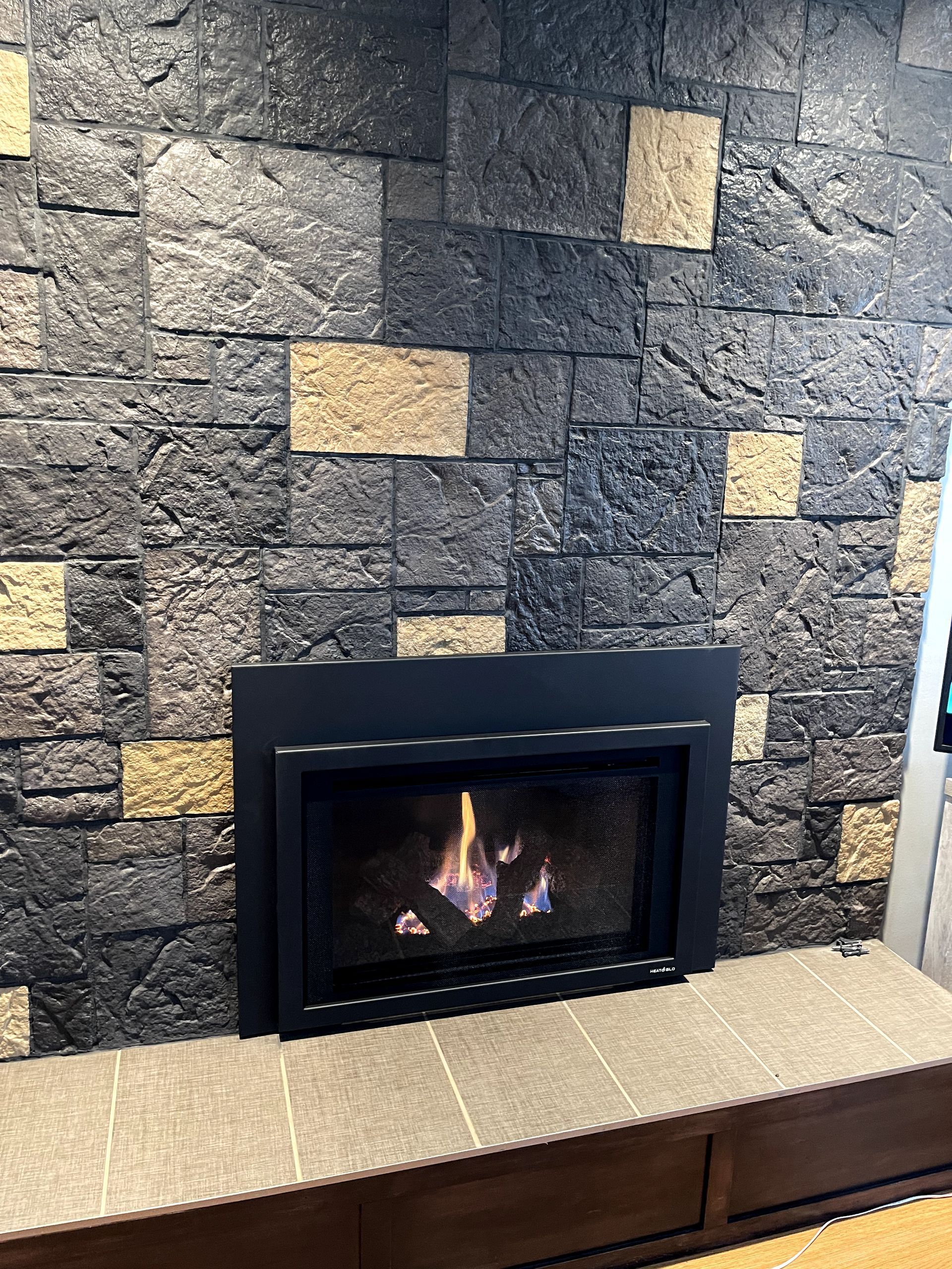 A fireplace with a brick wall behind it