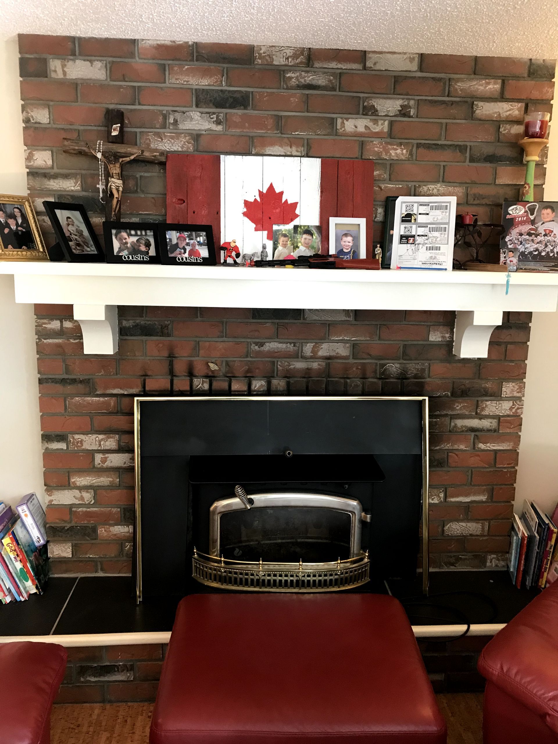 A living room with a fireplace and a canadian flag on the mantle