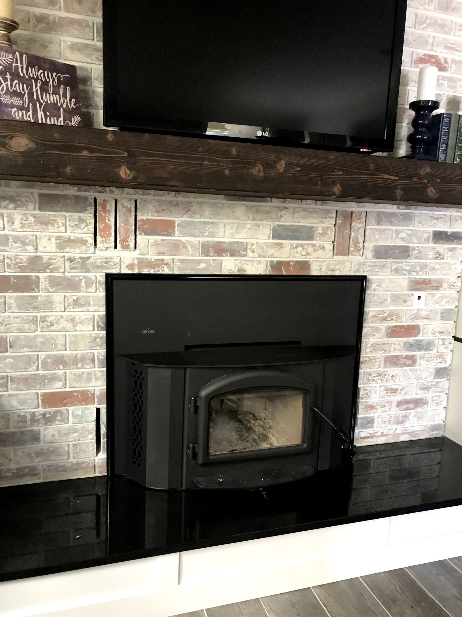 A living room with a fireplace and a flat screen tv.