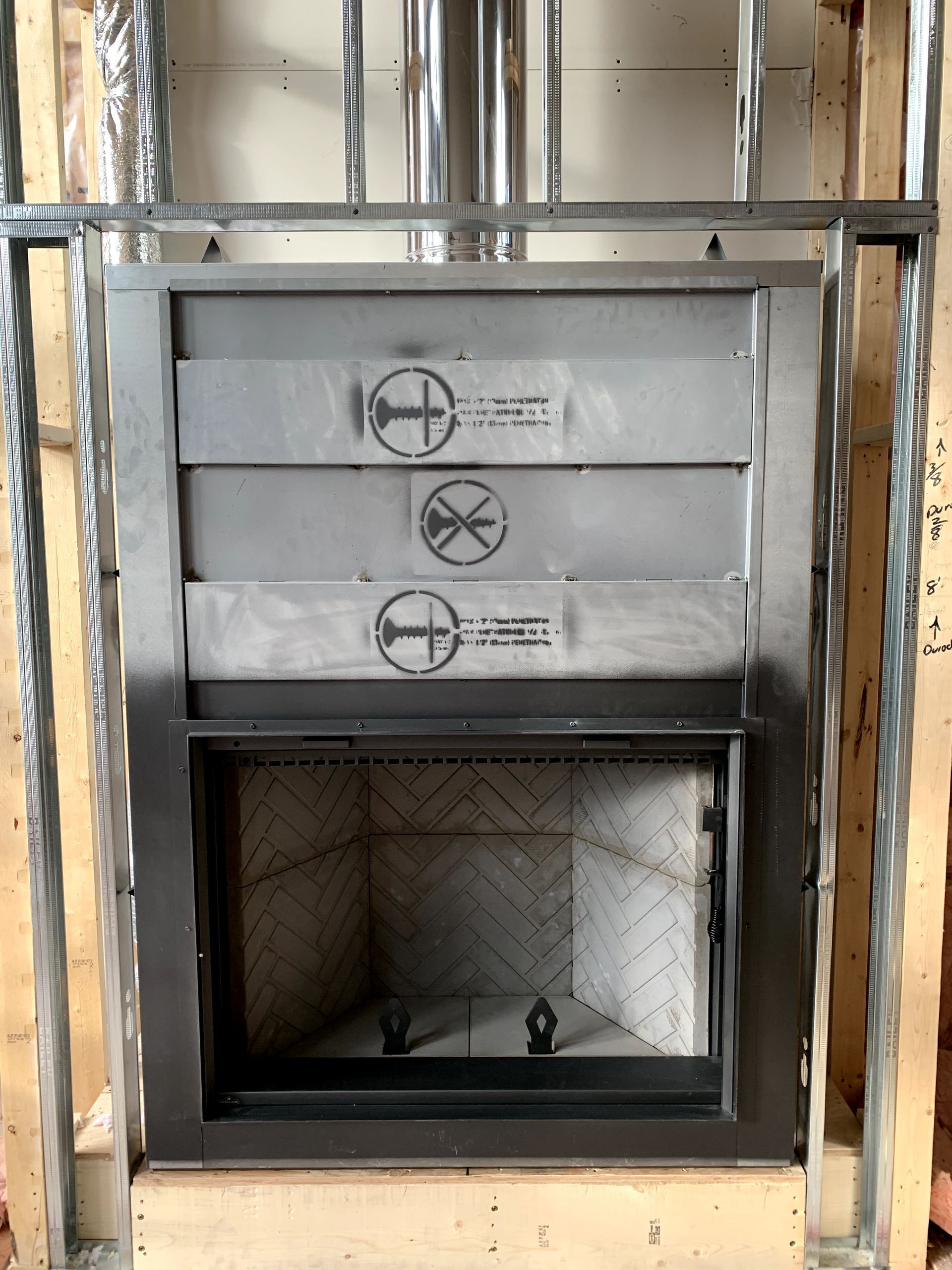 A fireplace is being built in a wooden frame.