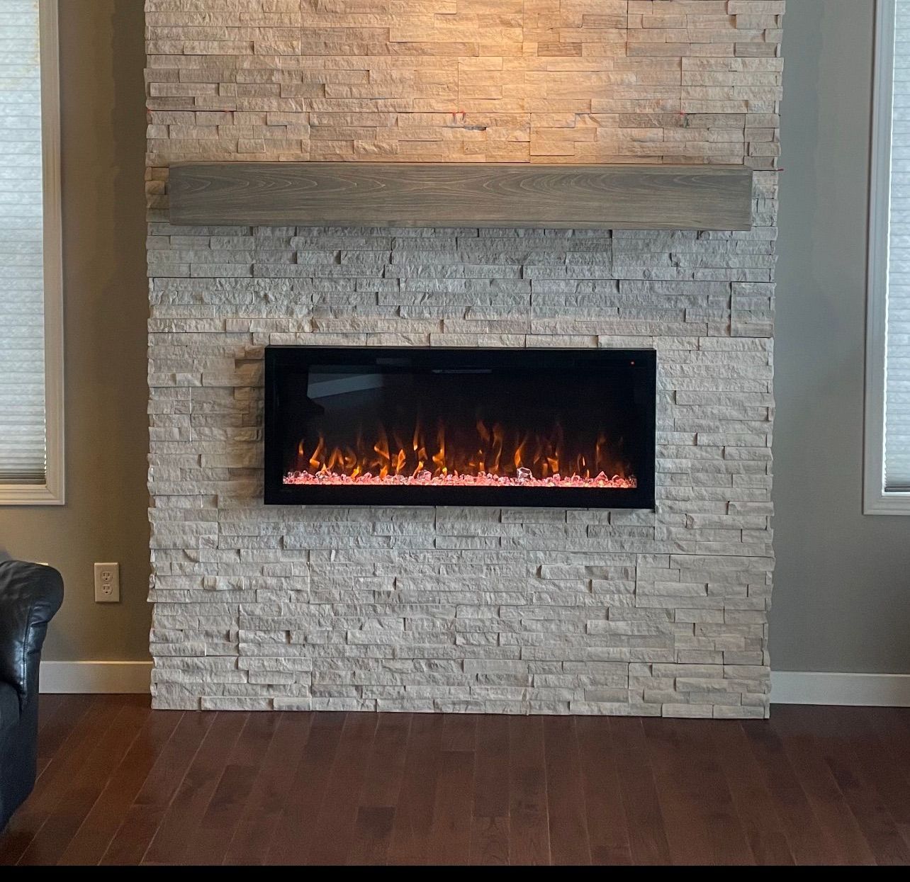 A fireplace with a brick wall and a shelf above it