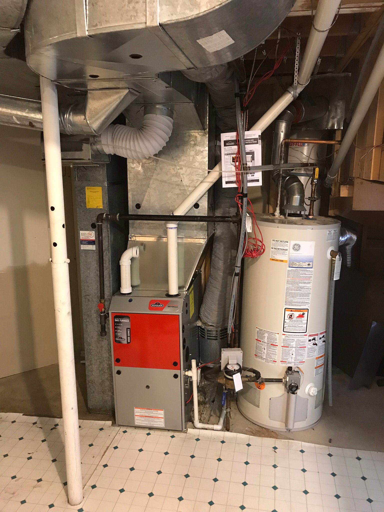 A basement with a water heater and a furnace.