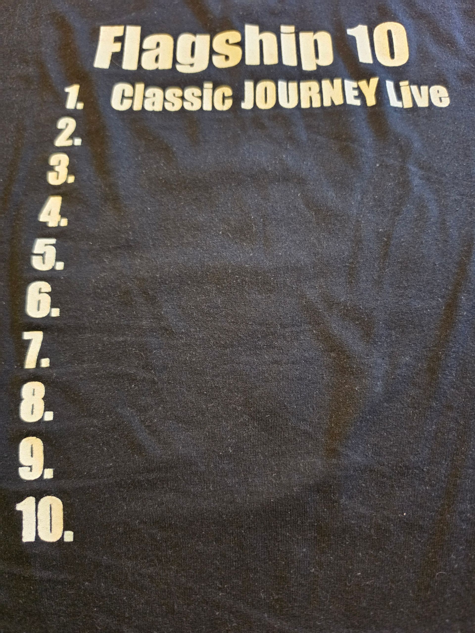Black T-shirt with “Flagship 10” text and a circular logo printed on the chest