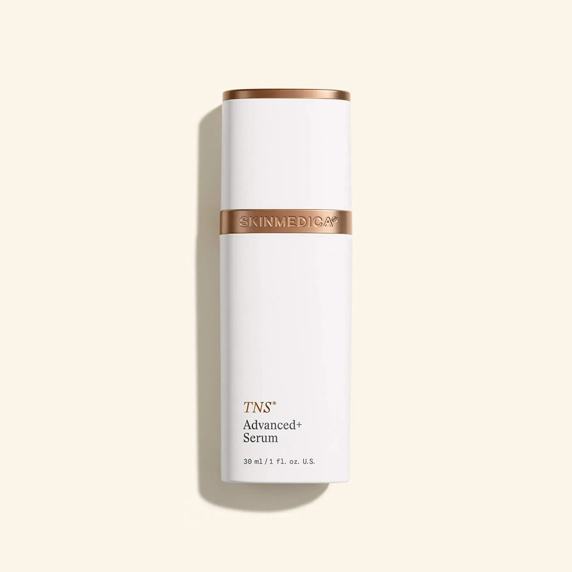 White and gold YNS Advanced Serum bottle on a beige background