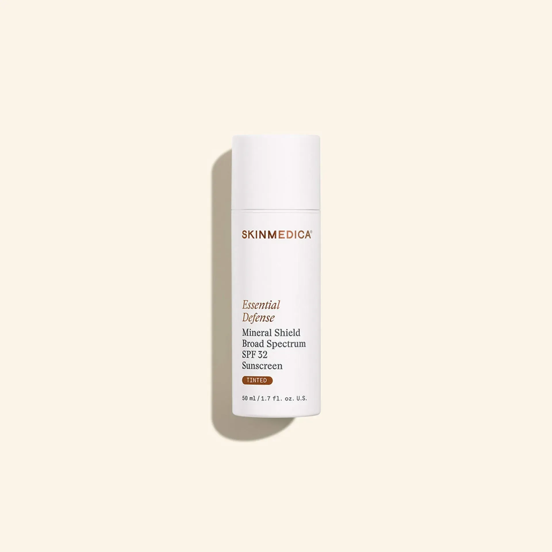 White skincare serum bottle with shadow on a beige background