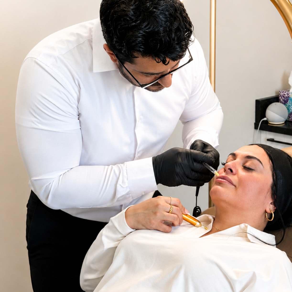 Nurse practitioner using a syringe on a reclining patient in a clinical exam room