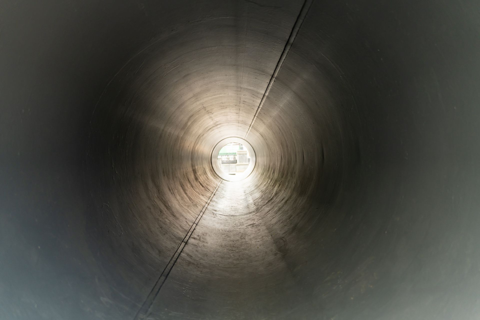 Interior view of a smooth, newly lined pipe showcasing professional cast iron pipe relining services.