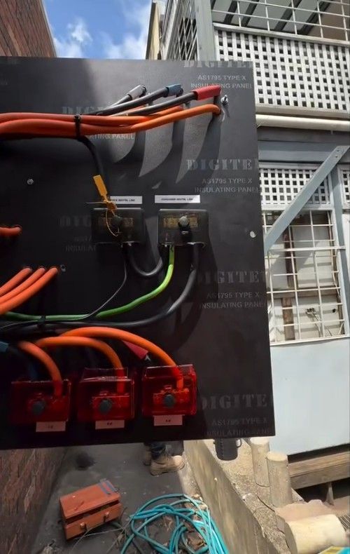 Black Electrical Panel with Red, Orange, and Green Cables — SRB Electrical Contracting Pty Ltd In Davistown, NSW