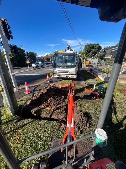 Two Utility Trucks with A Crane at A Roadside Work Area — SRB Electrical Contracting Pty Ltd In Davistown, NSW