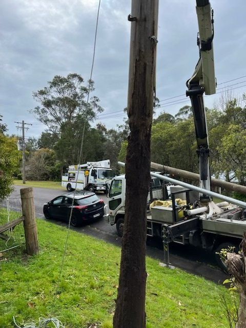 Utility Trucks and Workers Repairing Power Lines on A Roadside — SRB Electrical Contracting Pty Ltd In Davistown, NSW