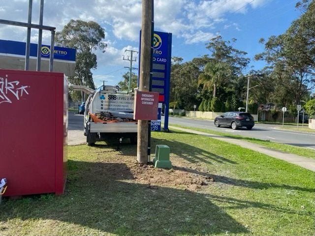 White Pickup Beside a Blue Roadside Sign on A Grassy Verge — SRB Electrical Contracting Pty Ltd In Davistown, NSW