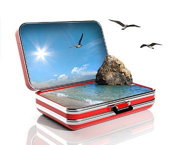 Red tin box open to reveal a sunny beach scene with waves, a rock, and flying seagulls.