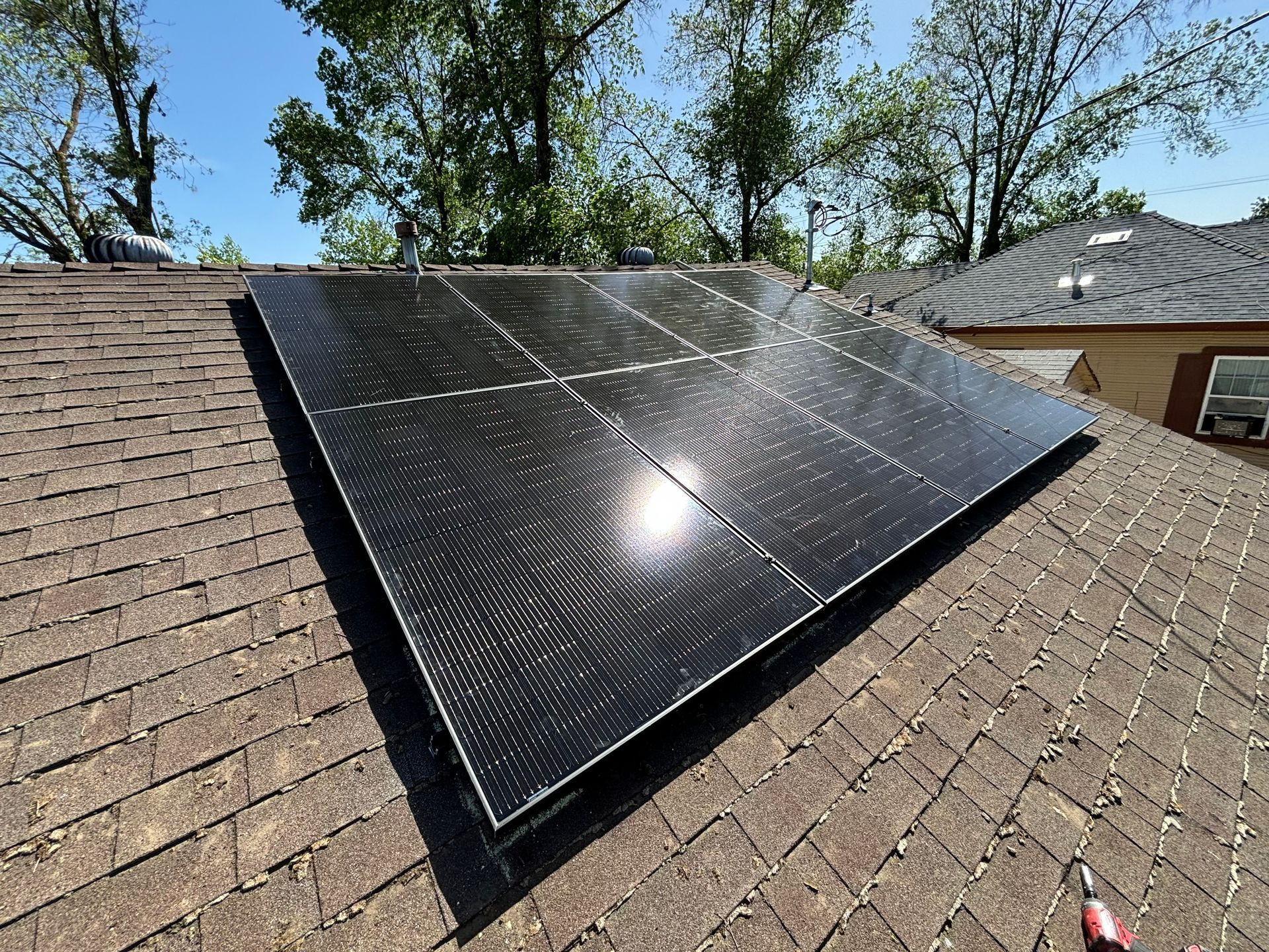A solar panel is sitting on top of a roof.