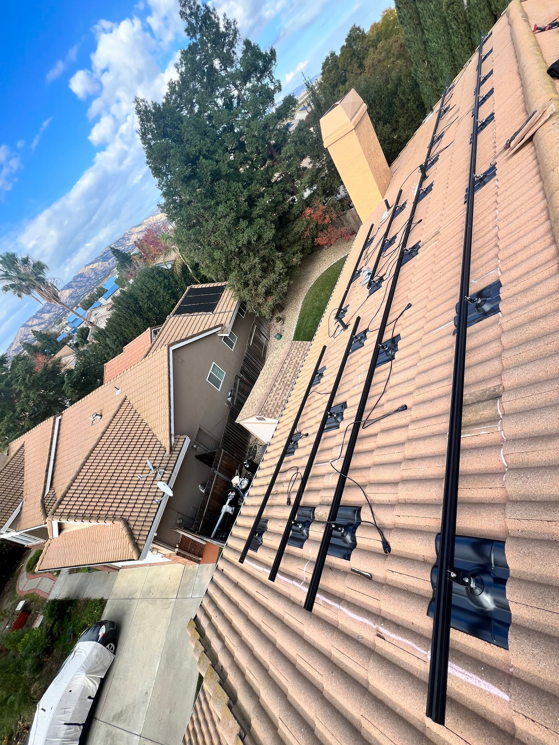 An aerial view of a roof with solar panels on it.