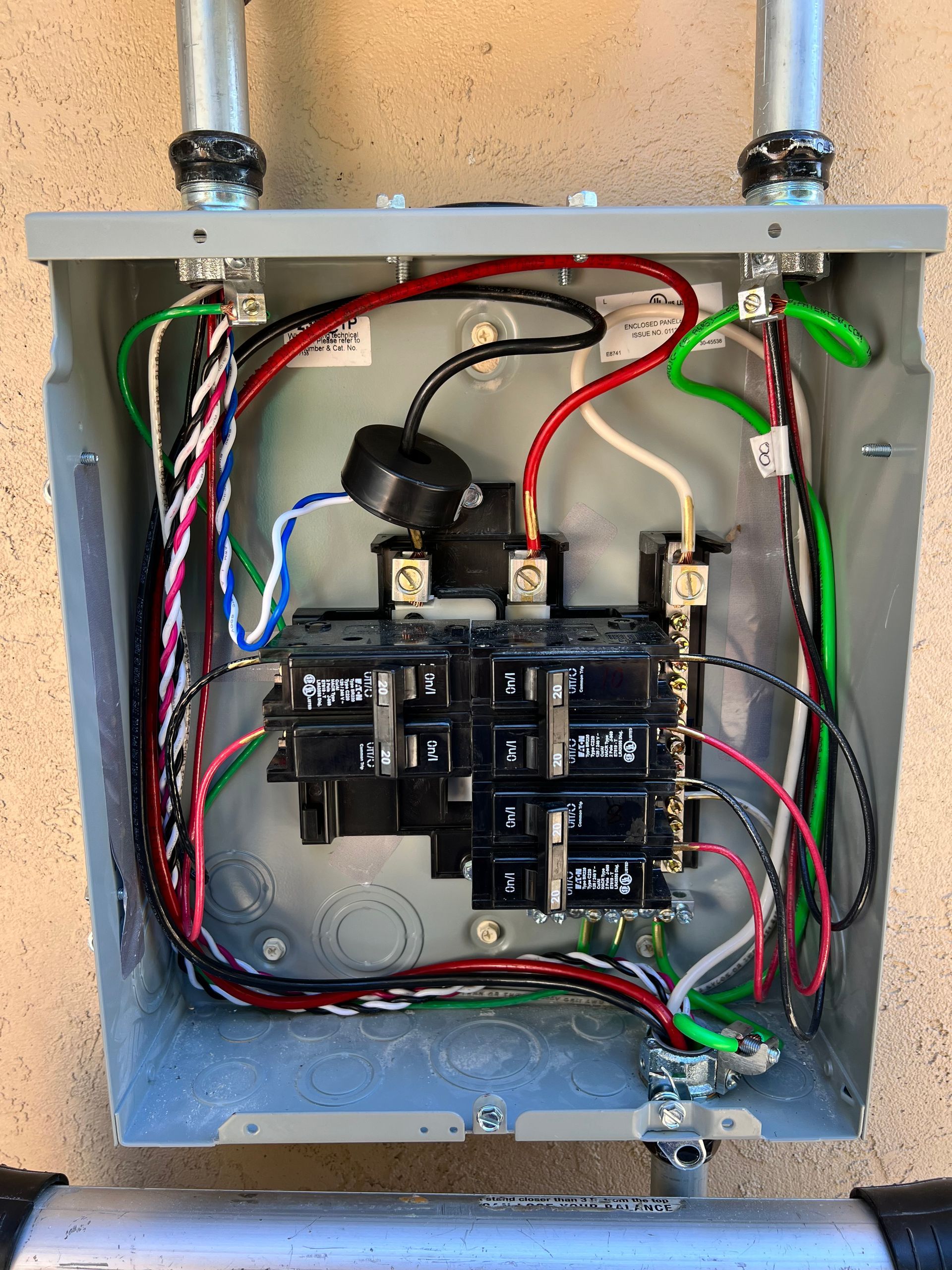 A electrical box with a lot of wires coming out of it.