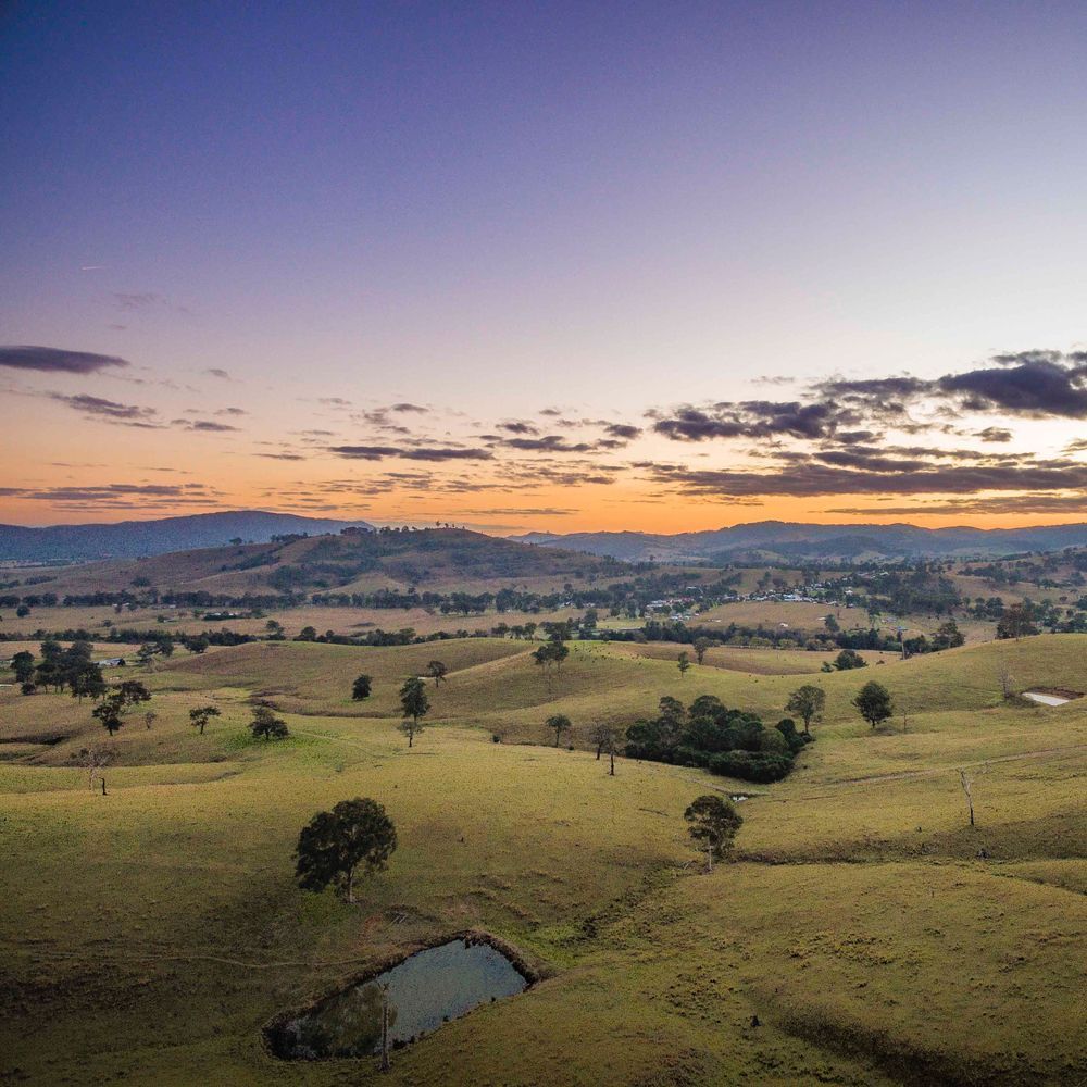 An Aerial View Of A Landscape With A Sunset In The Background — MC Plastering In Maitland, NSW