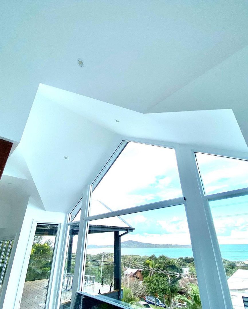 A Room With A Lot Of Windows And A View Of The Ocean — MC Plastering In Newcastle, NSW