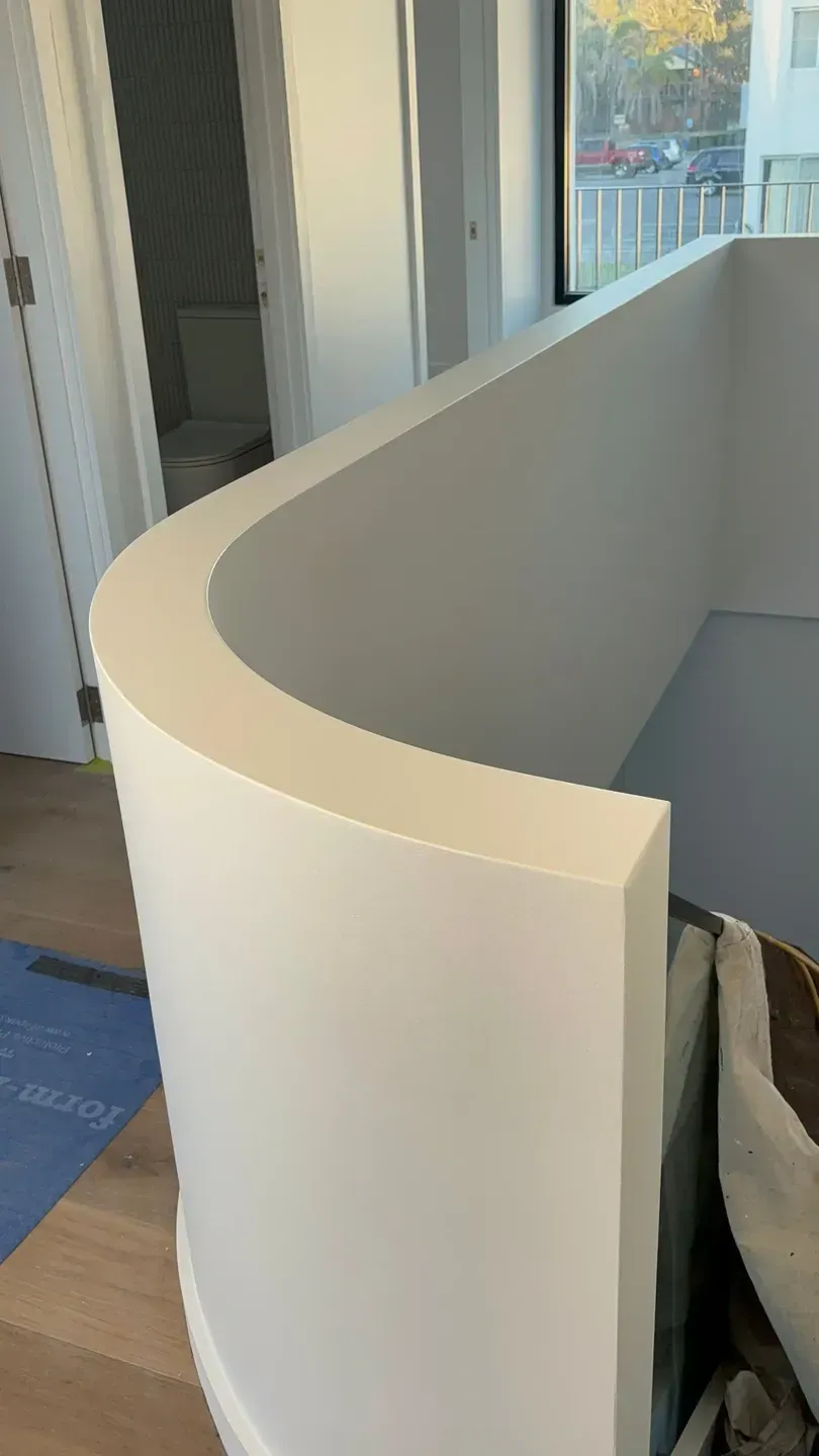 A Close Up Of A Curved Railing On A Staircase In A House — MC Plastering In Fingal Bay, NSW