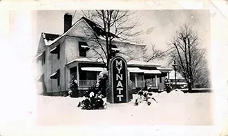 Exterior of Mynatt Funeral Home, Inc. in black and white during winter