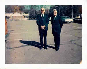 Two funeral directors in parking lot for Mynatt Funeral Home, Inc.