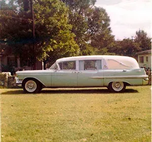 Light green older version of hearse Mynatt Funeral Home, Inc.