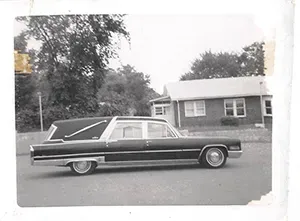 Black and white photo with hearse in front of Mynatt Funeral Home, Inc.
