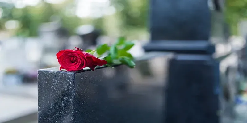 Cemetery monument with rose on top, monuments offered by Mynatt Funeral Home