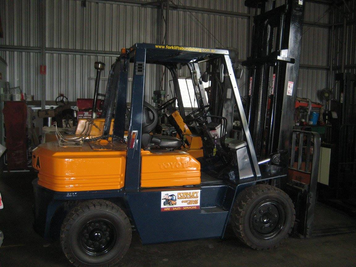 Orange and Black Forklift Parked Inside a Warehouse — Forklift Repairs & Spares In Hervey Bay, QLD