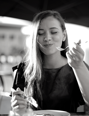 dental wellness | Woman eating and smiling | Nutrition Counseling | Family Dentist in Leawood, KS 66209