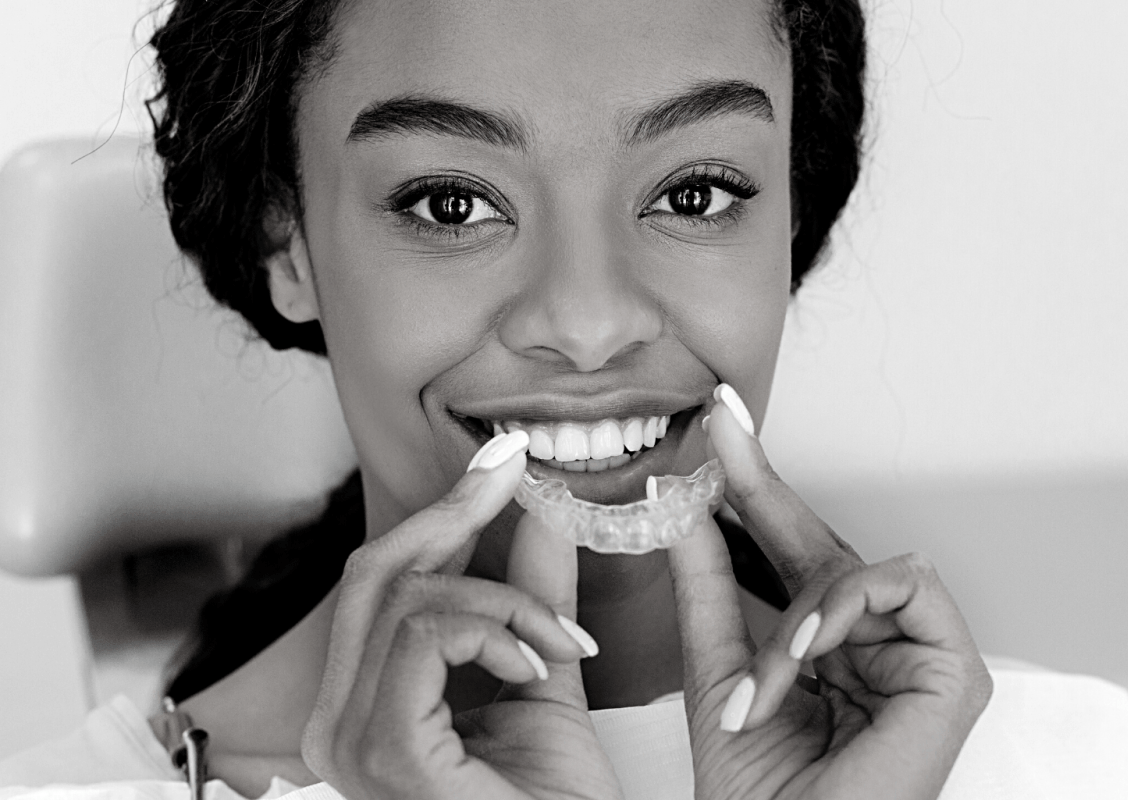 Woman smiling with straight teeth | Get clear aligners in Leawood 66209.
