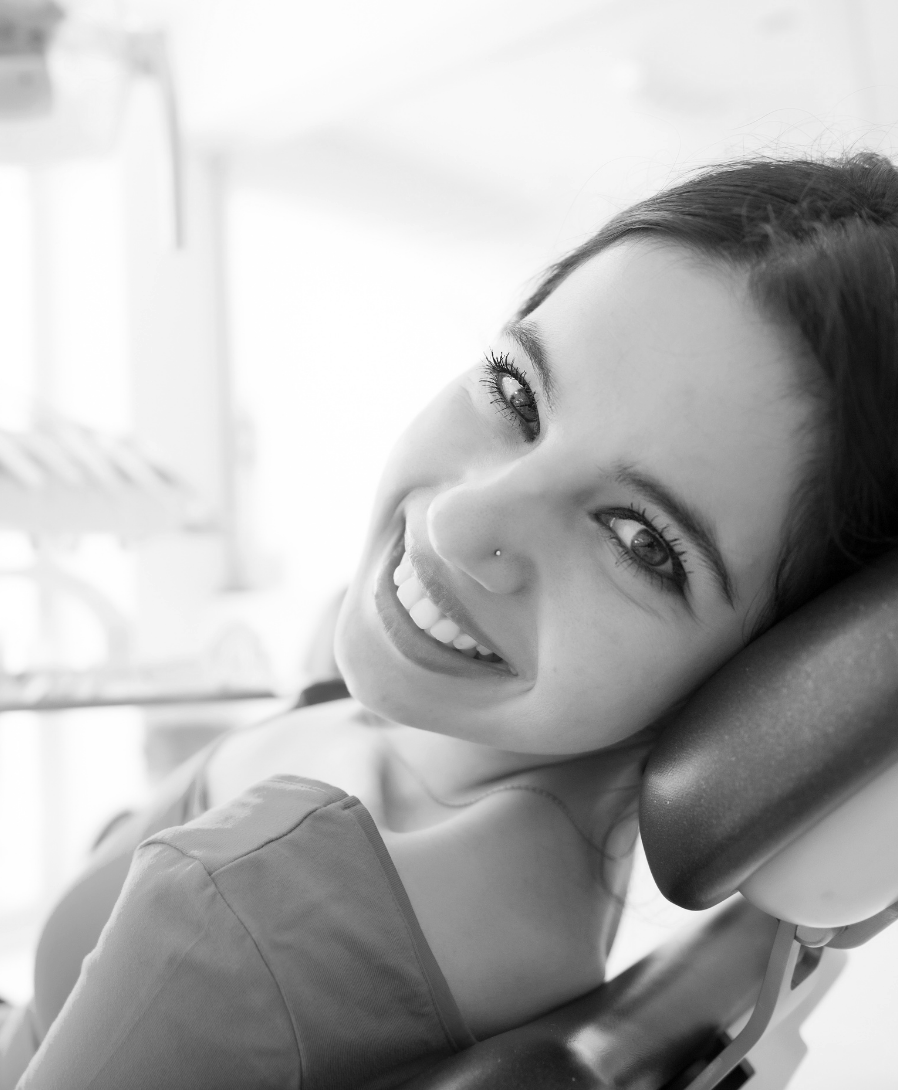 Woman smiling pain-free | Visit the best dentist in Leawood 66209 for root canals. Preventative dental care