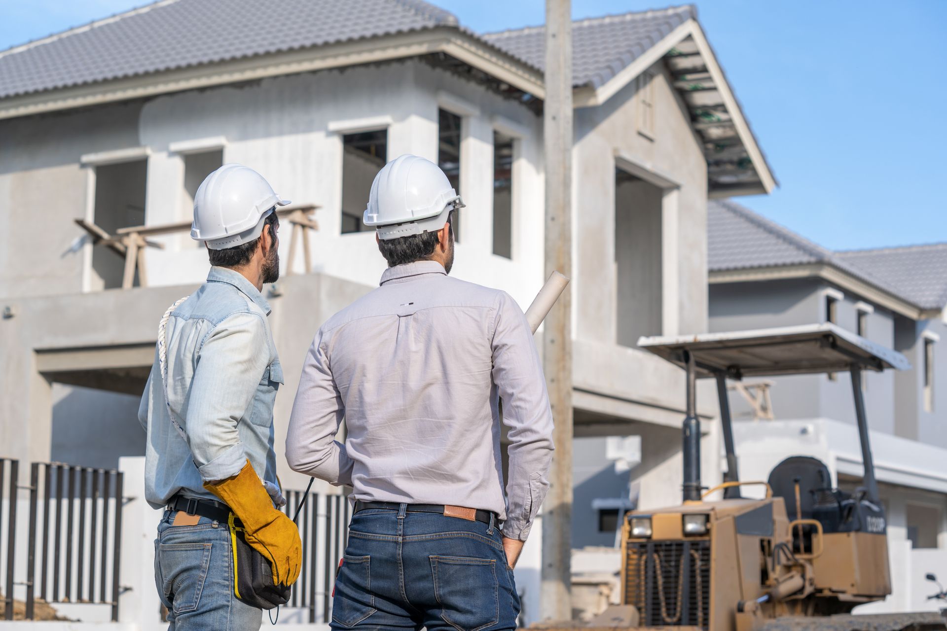 Custom home construction team inspecting a new residential build at an active job site.