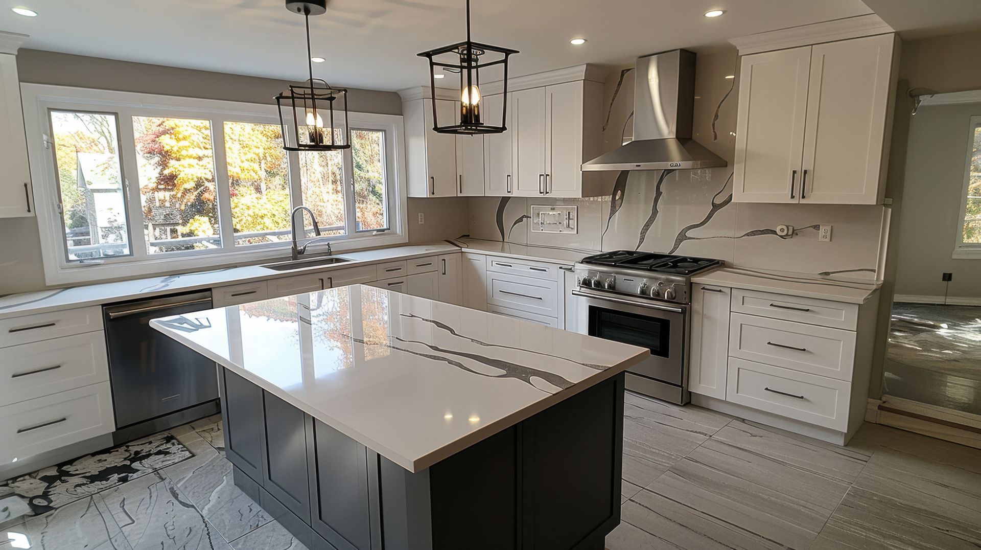 Modern white kitchen with marble countertops, island, and stainless appliances