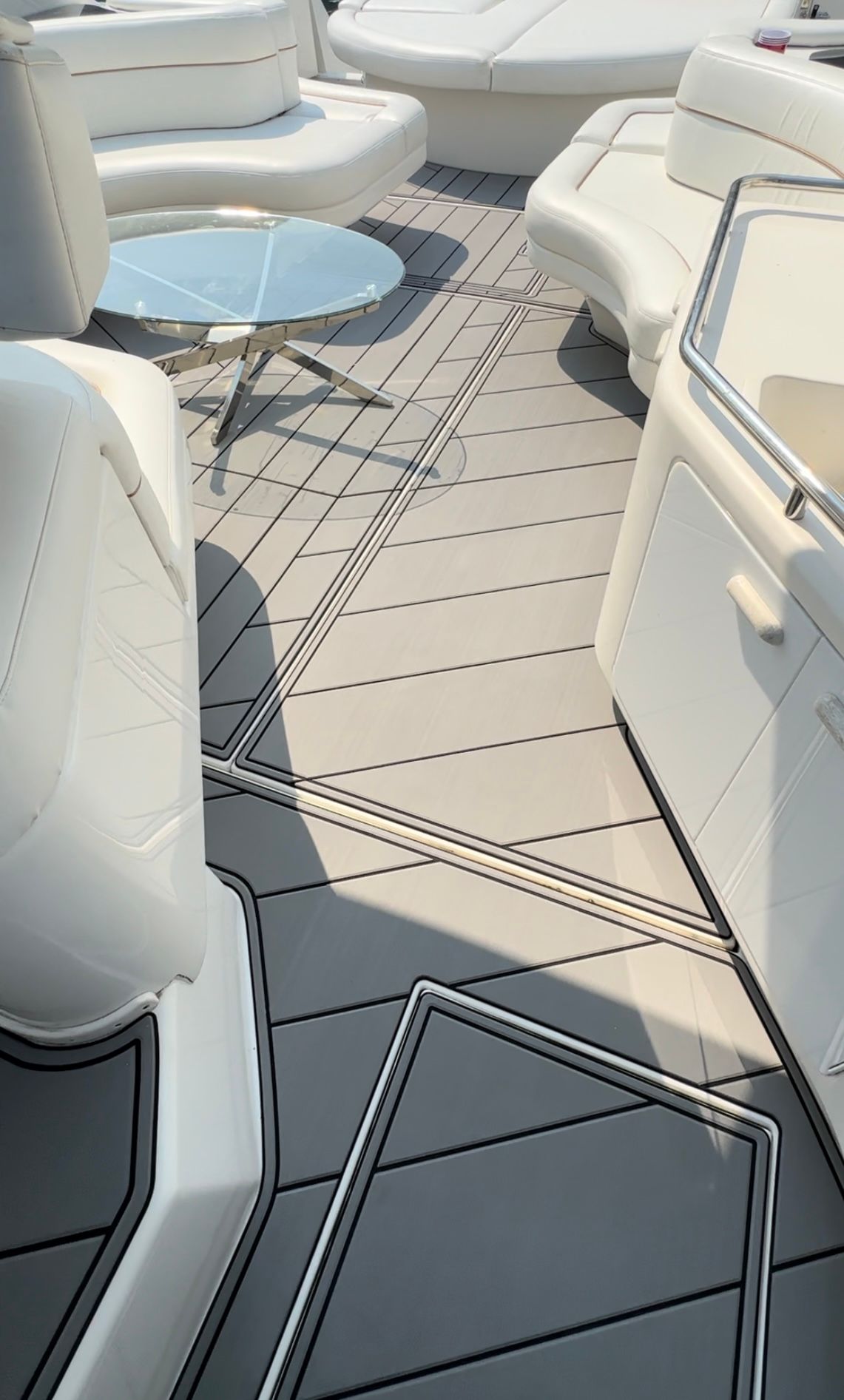 A boat with a table and chairs on the deck.