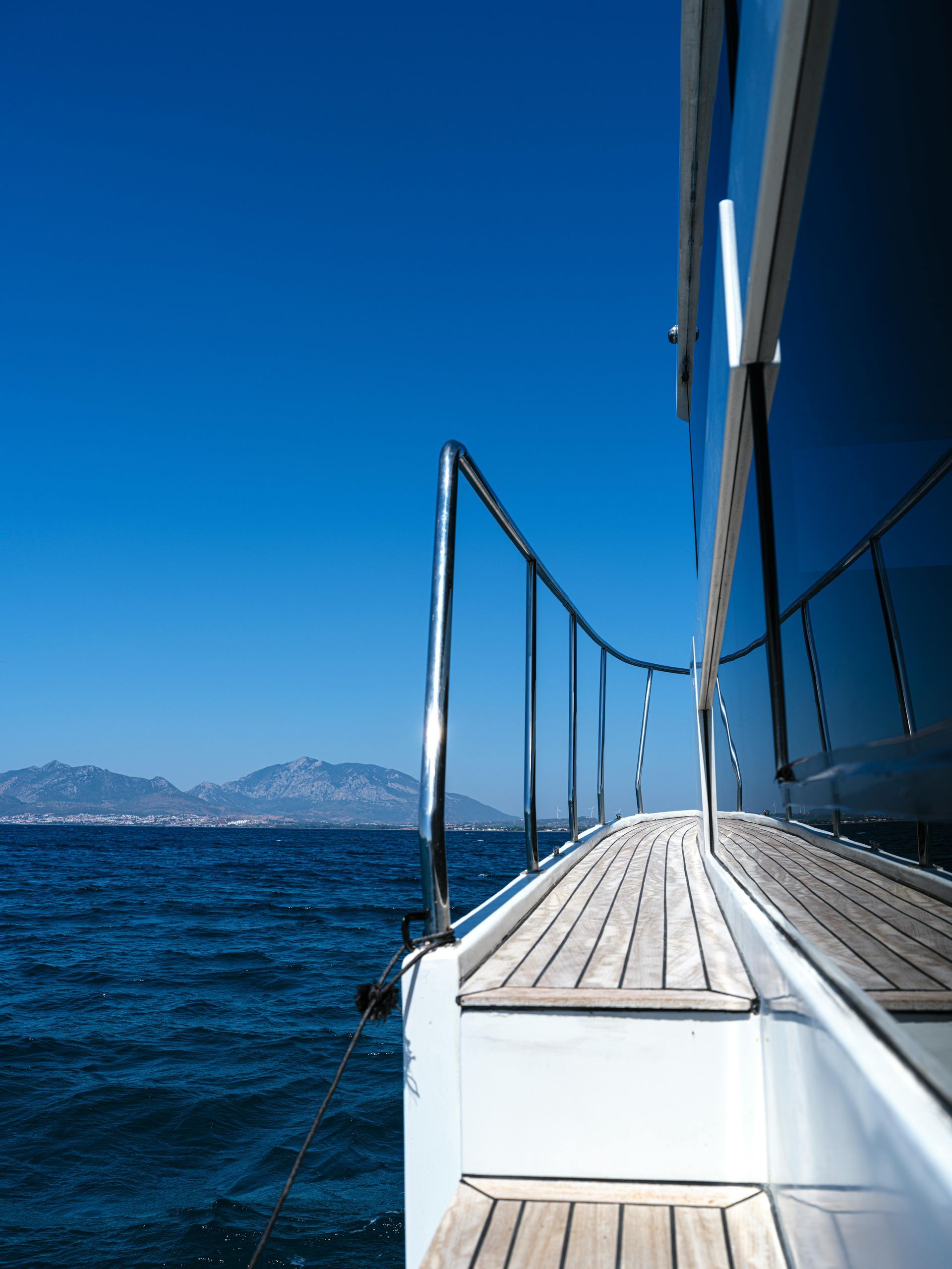 A boat with a wooden deck going into the ocean